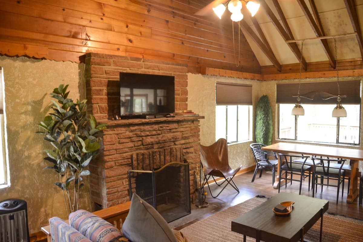 A cozy living room with a fireplace, a television, and comfortable seating.