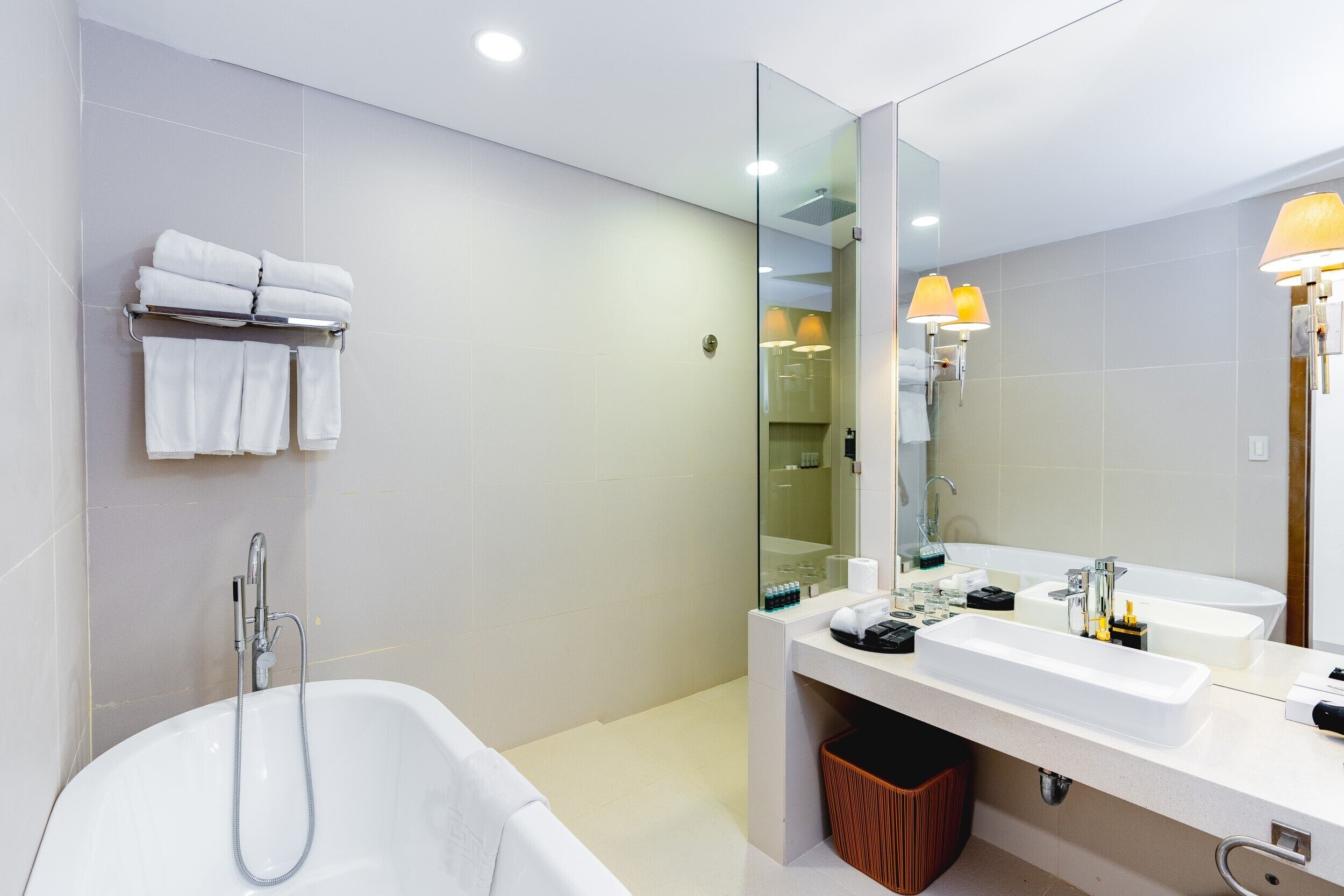 A modern bathroom with a large bathtub, two sinks, and a mirror.