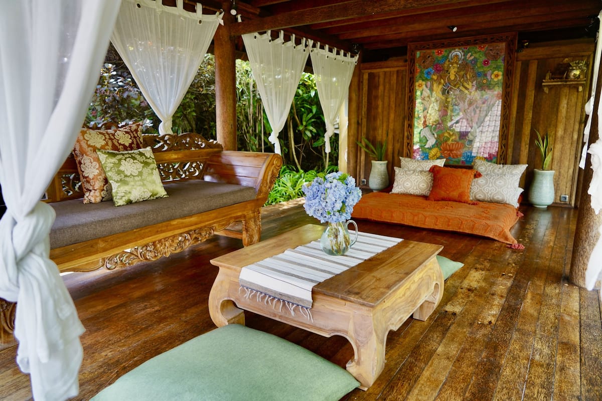 A cozy room with a wooden bench, a cushioned sofa, and a wooden coffee table.