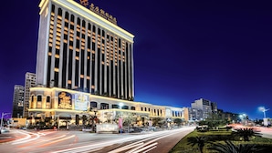 A high-rise hotel with a prominent sign at the top.