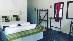 A hotel room with a bed, a bedside table, a window with a red curtain, a wall-mounted air conditioner, and a small shelf with a kettle and cups. - Papillon Bungalows (Ko Lanta)
