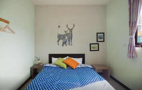A bedroom with a bed, a wall with a deer and bird mural, and two framed pictures. - Yushow Library Villa (Nanzhuang)