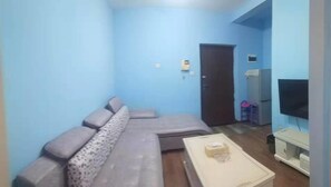 Habitación doble Deluxe | Área de sala de estar | Televisión de pantalla plana