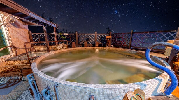A hot tub with a starry night sky in the background. - Shankou Hotspring Hotel (Jiaoxi)