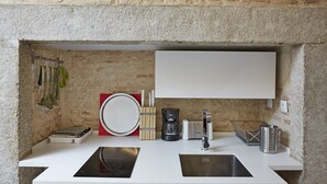 A modern kitchen with a white countertop, a built-in sink, a coffee maker, a toaster, and a knife block. - Sonel Investe Apartments Madalena 287 Studios (Lisbon)