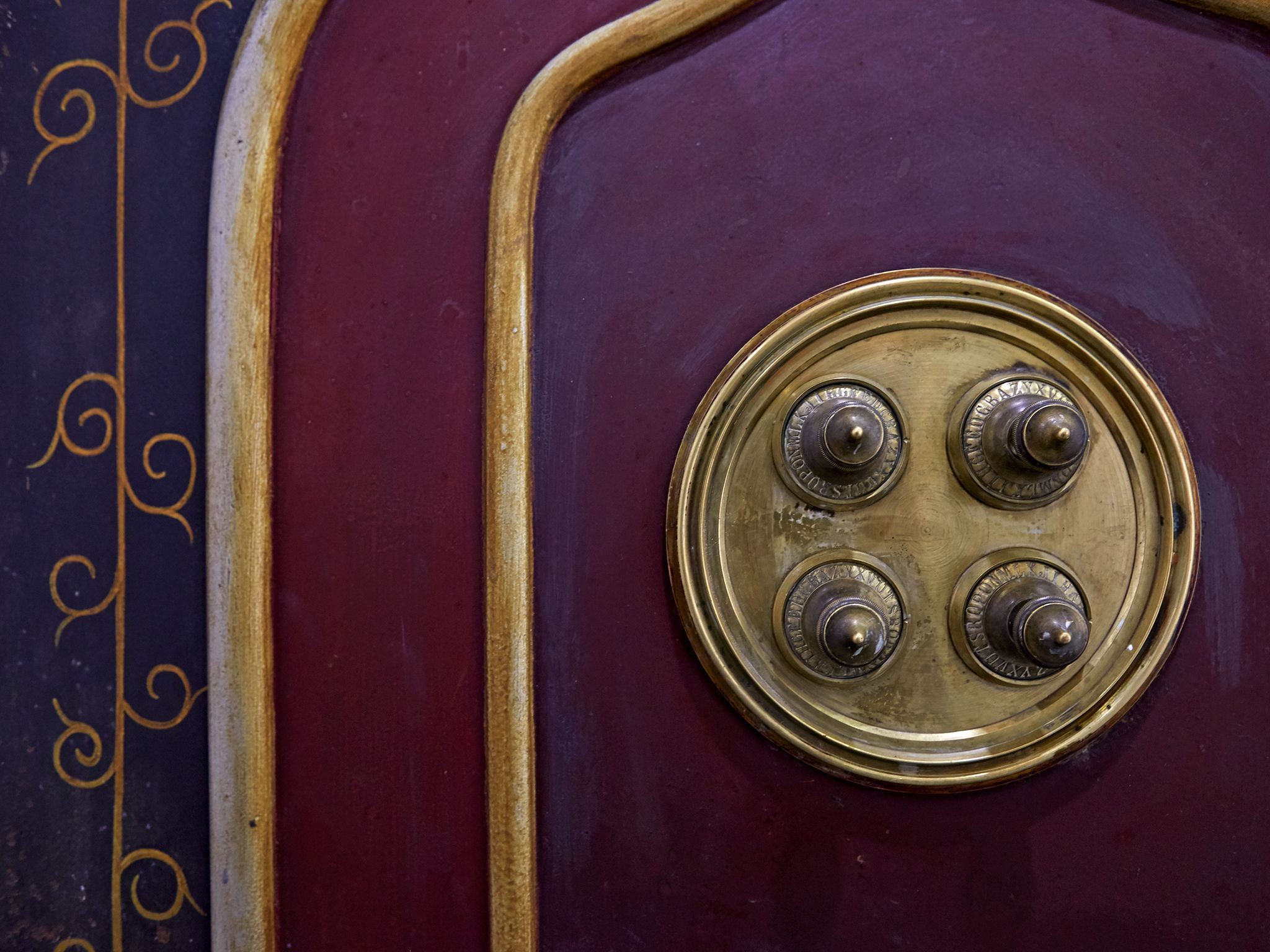 A close-up of a vintage radio with a circular dial and three knobs.