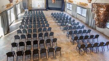 A conference room with rows of chairs arranged for a meeting.