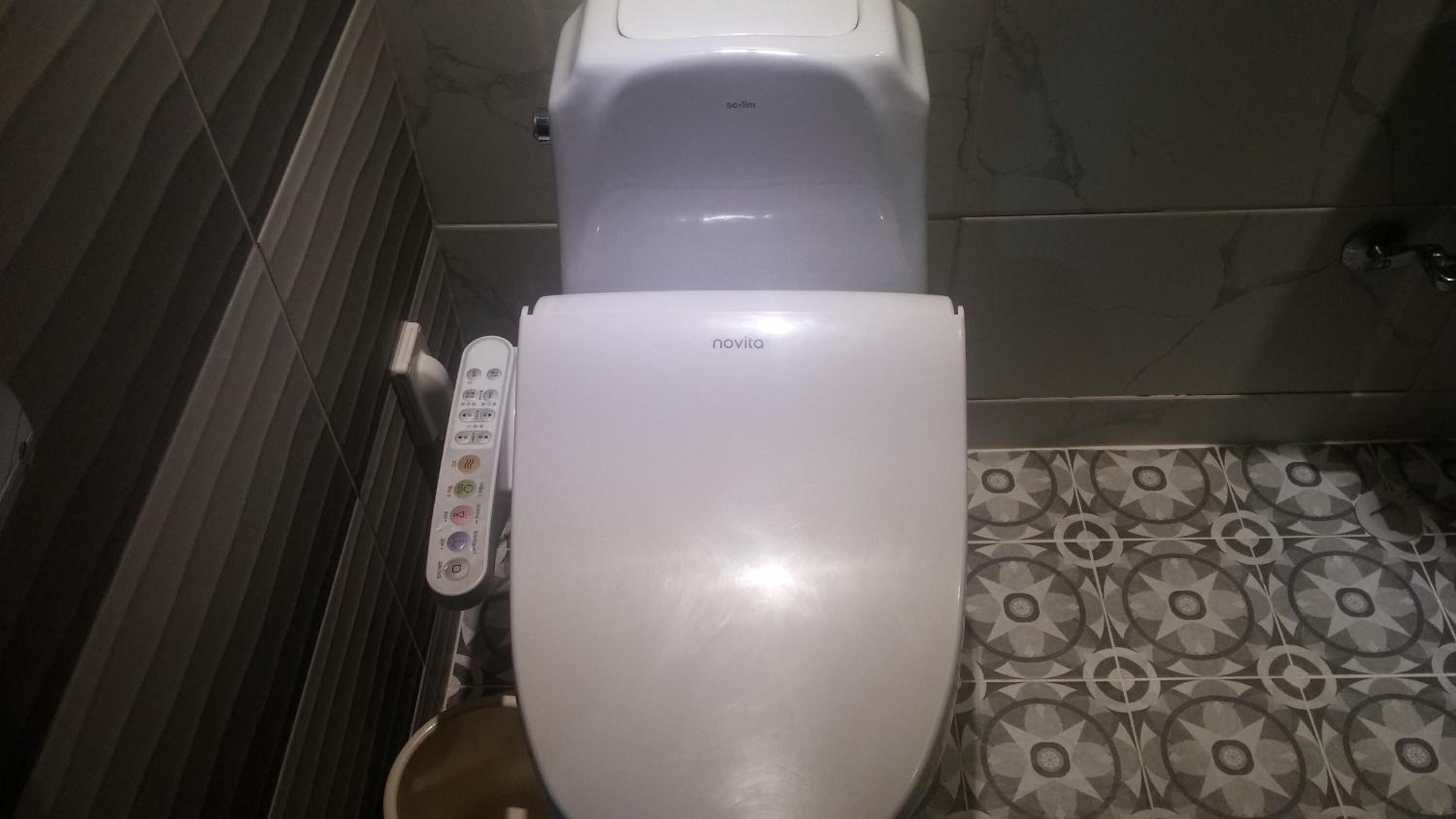 A toilet with a control panel and a brand name 'novita'.
