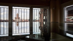 A room with a view of a historic tower across a body of water. - Locanda delle Mercanzie (Brescia)