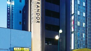A modern building with a prominent 'RANDOR' sign on its facade. - Randor Residence Susukino Suites (Sapporo)