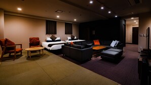 A modern hotel room with a bed, two sofas, a coffee table, and a TV. - Randor Residence Susukino Suites (Sapporo)