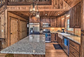 Enjoy cooking in this well-equipped kitchen with a central island, stainless steel appliances, and microwave.