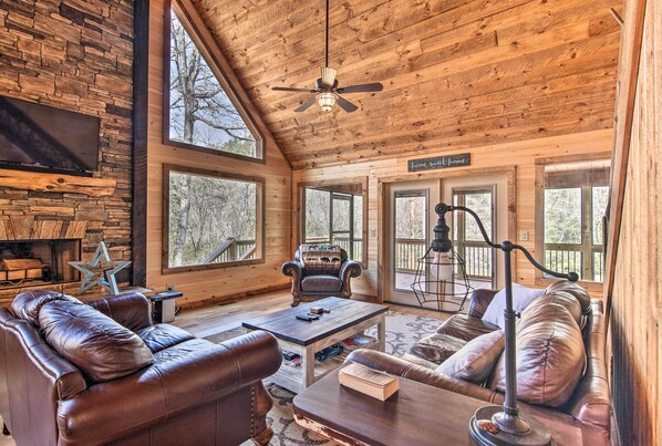 Relax in this inviting living room with a fireplace, flat-screen TV, and comfortable seating.
