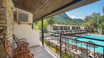 Deluxe Room, Balcony, Pool View | Premium bedding, minibar, soundproofing, iron/ironing board