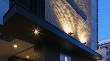 A modern building with a prominent 'RANDOR' sign, featuring a glass entrance and illuminated signage.
