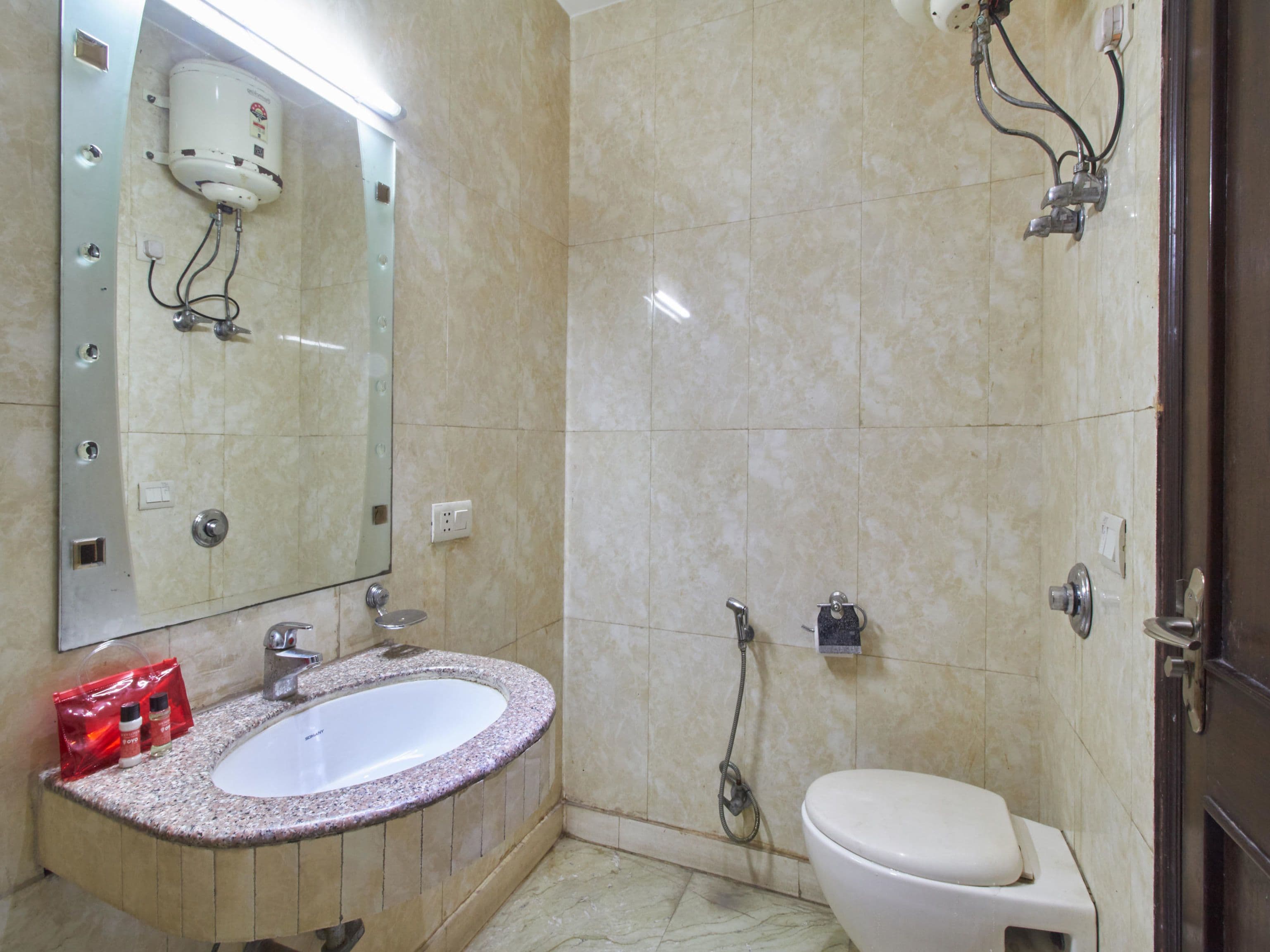 A bathroom with a marble sink, a toilet, and a shower.