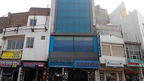A multi-story building with a prominent blue glass facade.