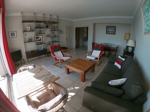 A living room with a sofa, two armchairs, a wooden coffee table, and a TV. There are shelves with decorative items and a painting on the wall. - cannes - exceptional view. 90m². 3 or 4 vacationers.  (Cannes)
