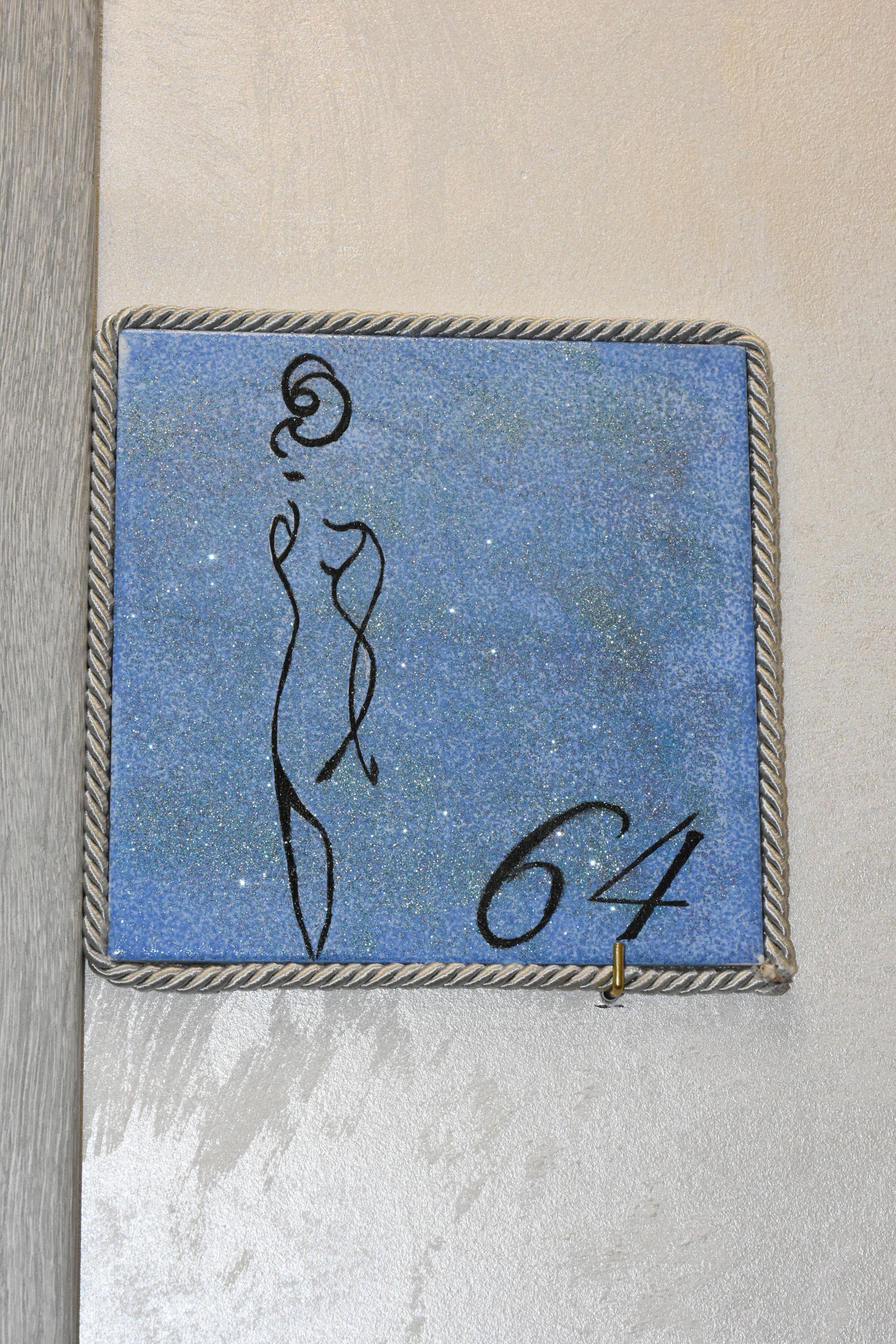 A framed artwork with abstract designs and the number 64.