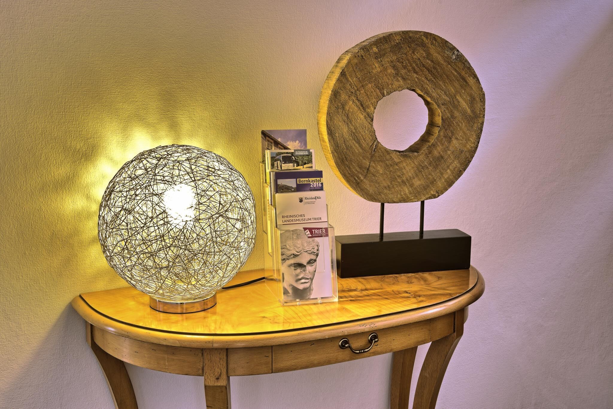 A wooden table with a globe, a framed picture, and a wooden plaque.