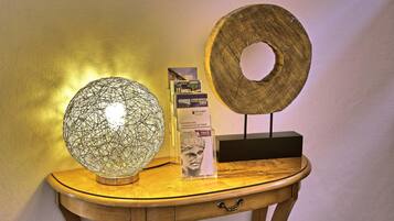 A wooden table with a globe, a framed picture, and a wooden plaque.
