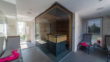Enjoy a serene space with a glass partition, wooden bench, and comfortable seating area.