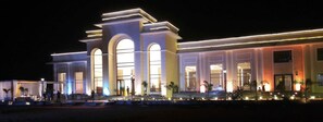 A large, modern building with multiple arched windows and a prominent entrance.