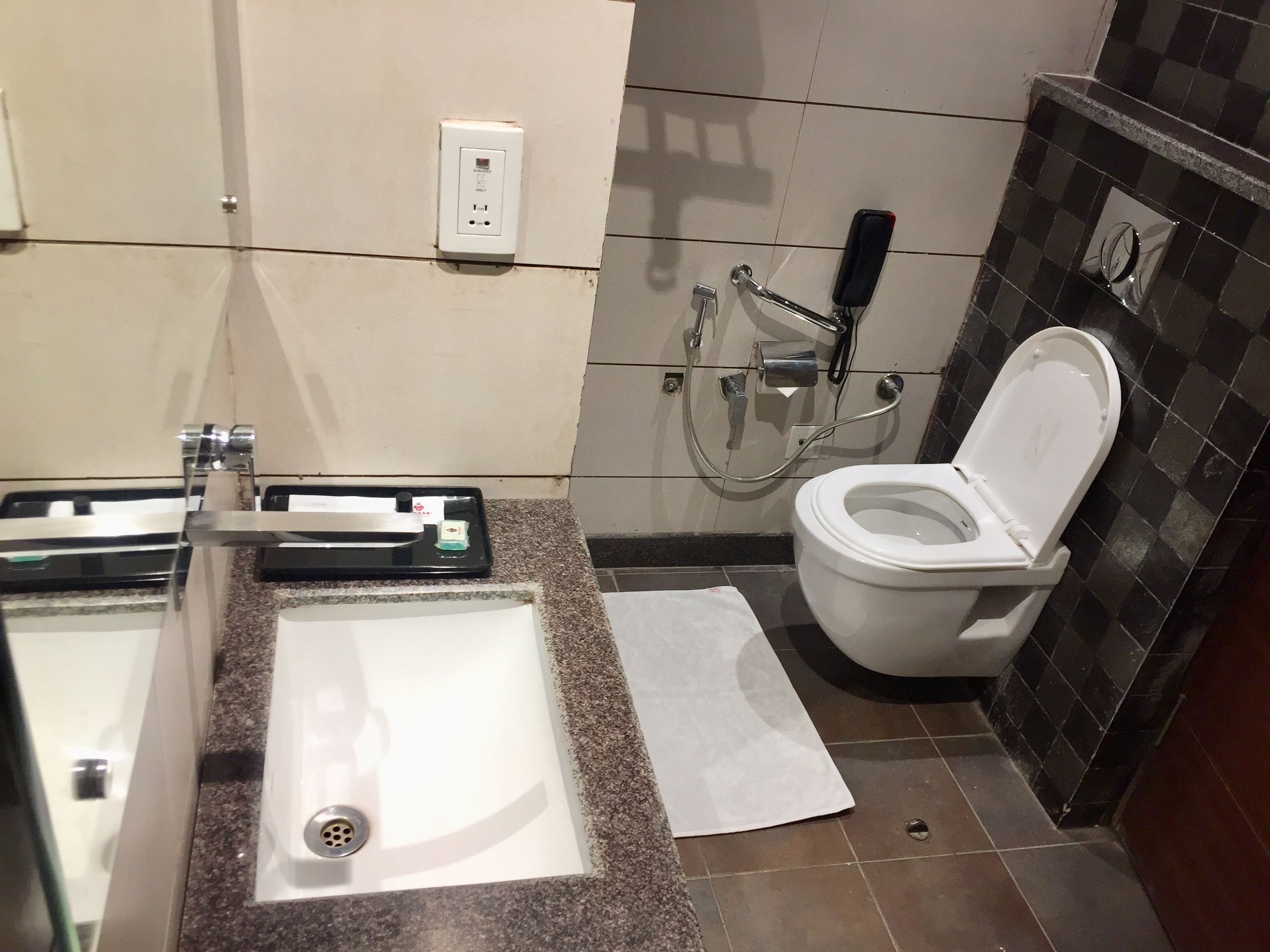 A bathroom with a sink, toilet, and shower.