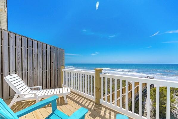 A wooden deck with white railings overlooking a beach. - Misty Morning South - Oceanfront 4BR Home; Dog Friendly! (Surf City)
