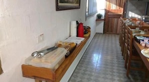 A kitchen with a long counter, a sink, and a window.