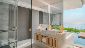 A modern bathroom with a glass-enclosed shower, a large mirror, and a dual sink vanity. - MASON, a member of Design Hotels (Sattahip)