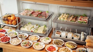 A buffet with various food items including fruits, salads, and sandwiches. - Hotel Platan (Gdansk)