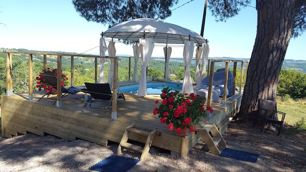 A wooden deck with a pool, outdoor seating, and a gazebo. - A wooden caravan at Domaine de la Morétie (CUBLAC)