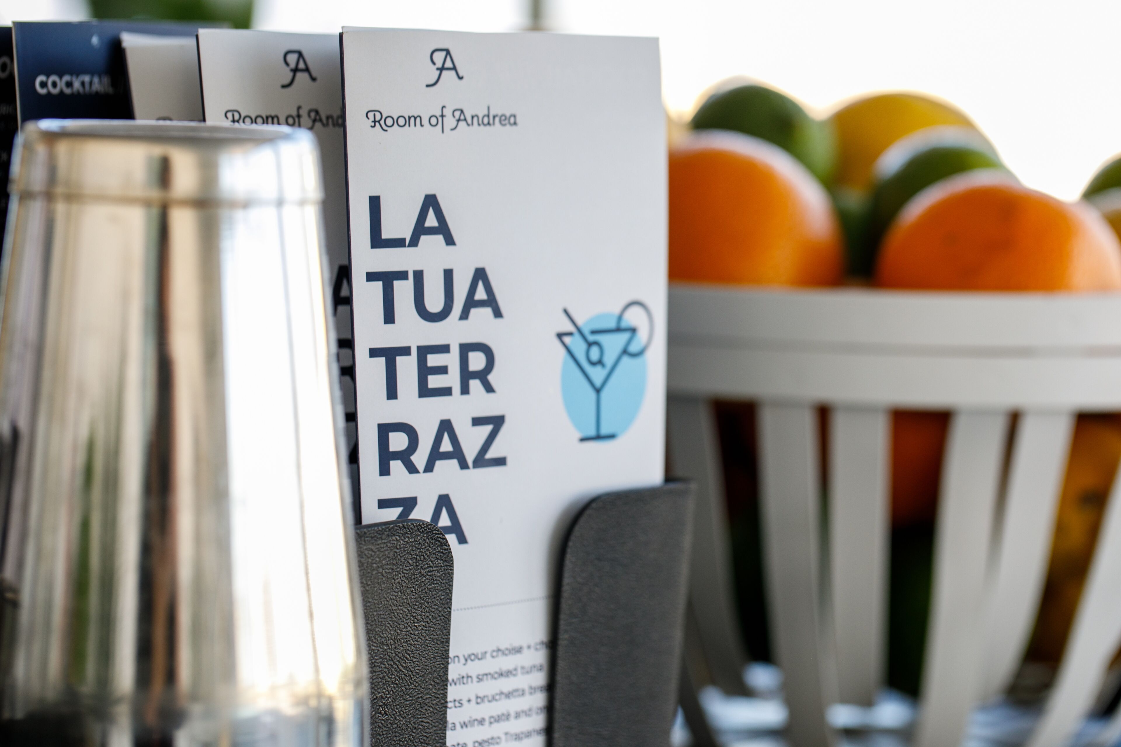 A menu with a cocktail option and a fruit bowl.