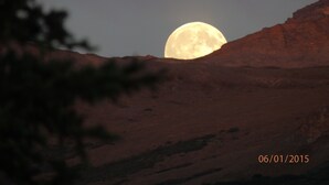 A landscape with a large moon in the sky, a mountain in the foreground, and a date stamp of 06/01/2015. -  Denali Wildlife Moose Cabin  Luxury with a touch of Rustic (Healy)