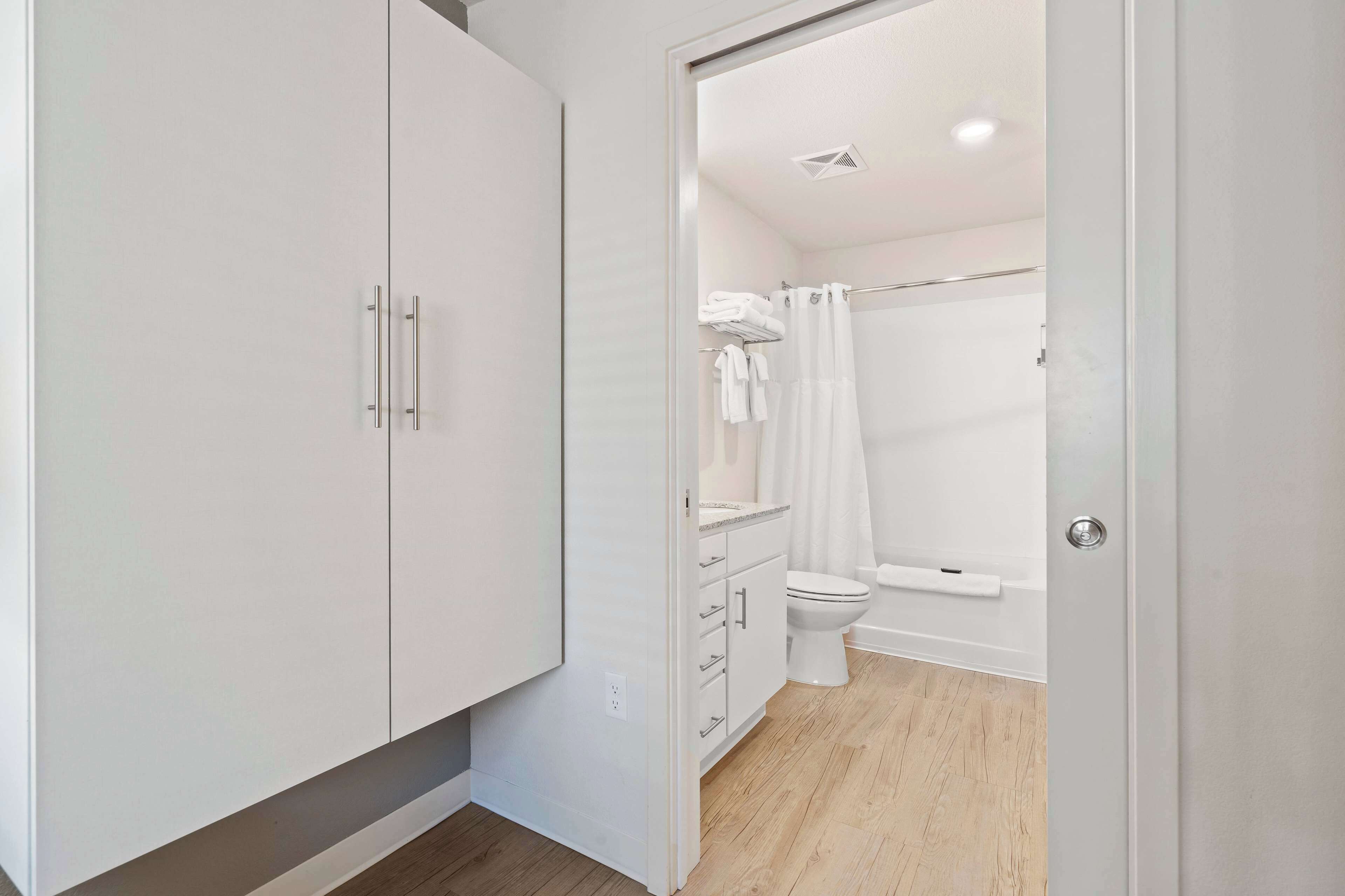 A modern bathroom with a toilet, sink, and shower area.