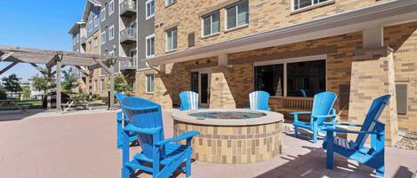 A courtyard with outdoor seating and a fire pit.