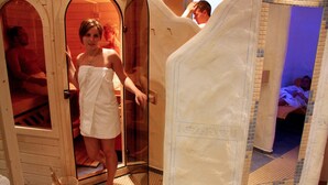 A sauna with wooden doors and a tiled floor. - Landhotel Napoleon (Wipperfuerth)