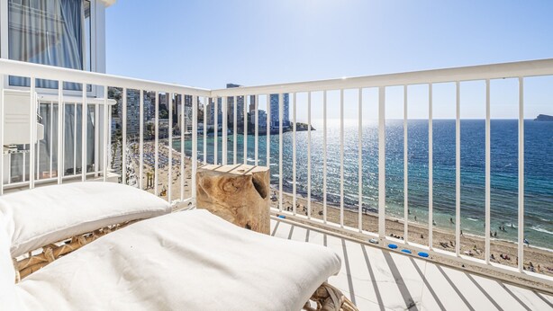 A balcony with white railings overlooking a beach and ocean. - Veracruz 11-B (Benidorm)