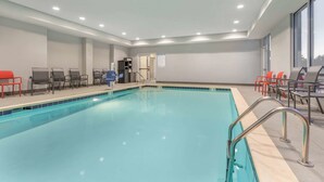 A swimming pool with chairs and a changing room.