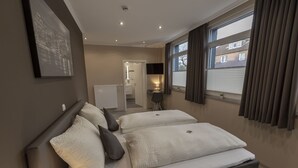A modern bedroom with a large bed, a walk-in closet, and a view of the city through the window.