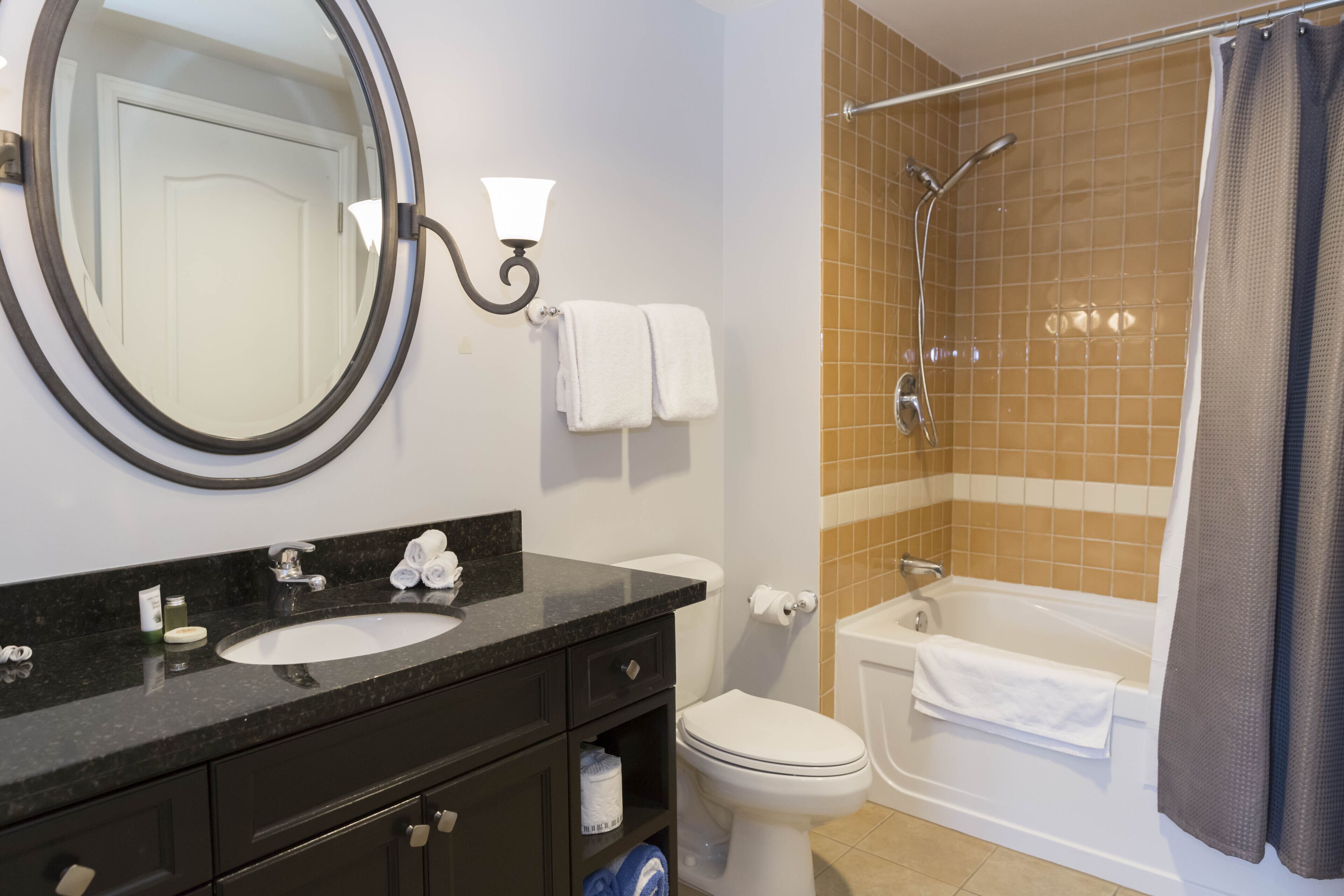 A bathroom with a sink, toilet, and bathtub.