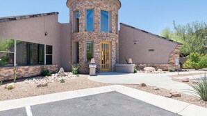A modern house with a stone tower, large windows, and a well-maintained garden. - Two Mountain Views in Gold Canyon (Gold Canyon)
