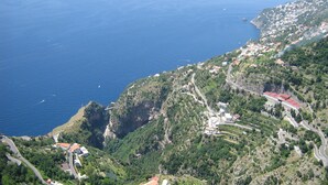 A coastal town with winding roads, buildings, and cliffs.