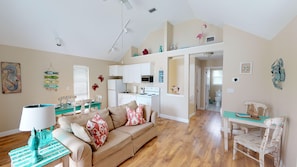 Relax in this inviting living space with a comfortable sofa, dining area, and fully equipped kitchen.