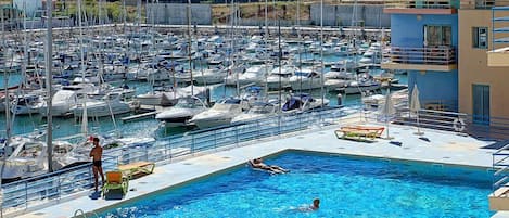 Outdoor pool, open 8:00 AM to 8:00 PM, pool loungers