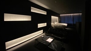 A modern hotel room with a bed, a desk, and a large window with curtains. - Randor Residence Hiroshima Suites (Hiroshima)