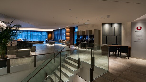 A modern hotel lobby with a glass staircase, seating areas, and a reception desk. - Daiwa Roynet Hotel Kyoto Terrace Hachijo PREMIER (Kyoto)