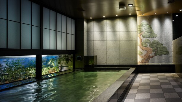 A modern indoor pool area with a view of greenery through large windows, a tiled floor, and recessed lighting. - Mitsui Garden Hotel Ginza Gochome (Tokyo)