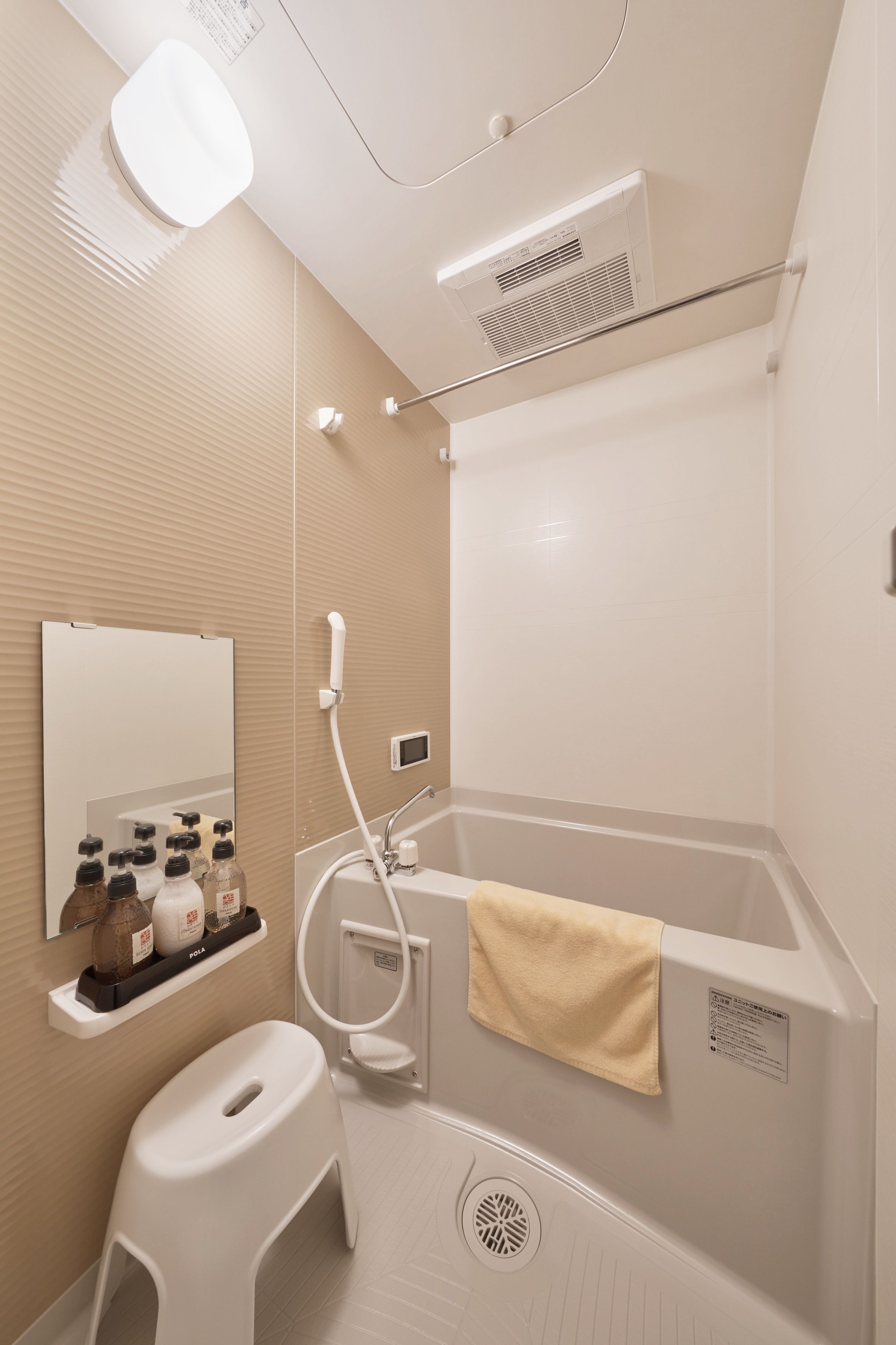A modern bathroom with a bathtub, a toilet, a sink, and a mirror.